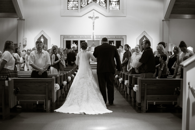 bride walking down the aisle with her father