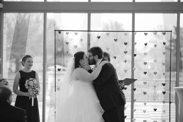 bride and groom kissing during ceremony