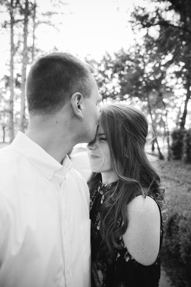 kissing forehead engagement photography