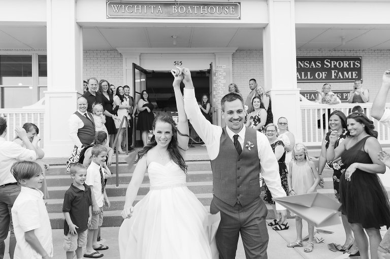 bride and groom exiting Wichita boathouse