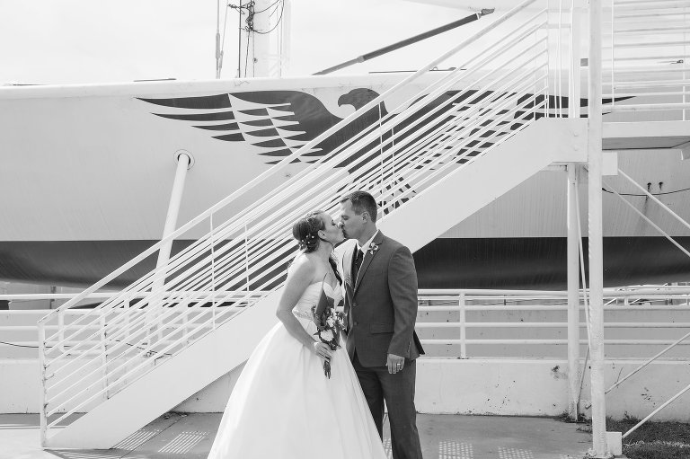 Bride and groom kiss at Wichita boathouse