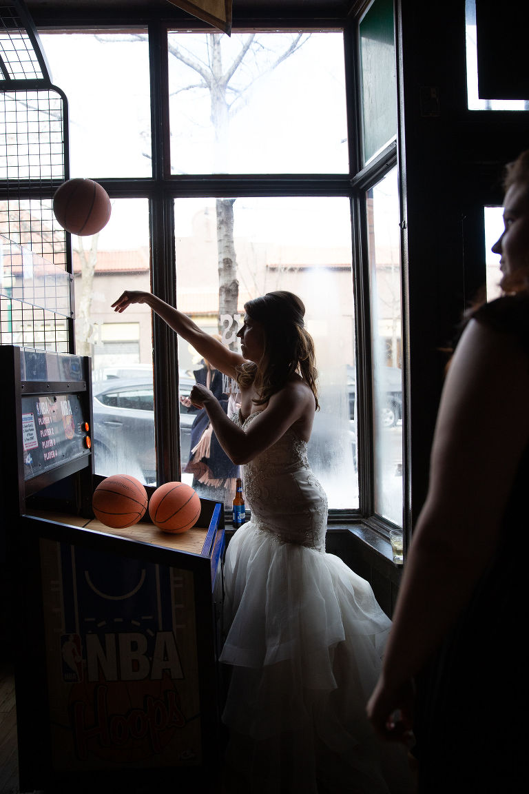 Bride playing basketball at Kelly's Pub